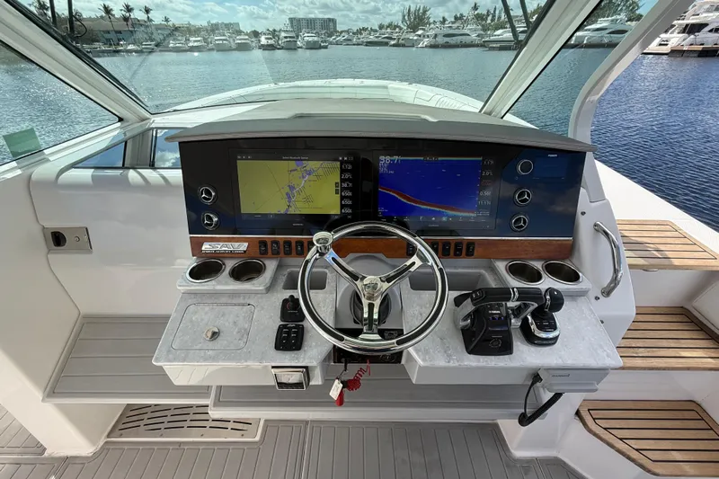  Yacht Photos Pics 2020 Regal 38 SAV helm with navigation screens and controls, docked at marina.