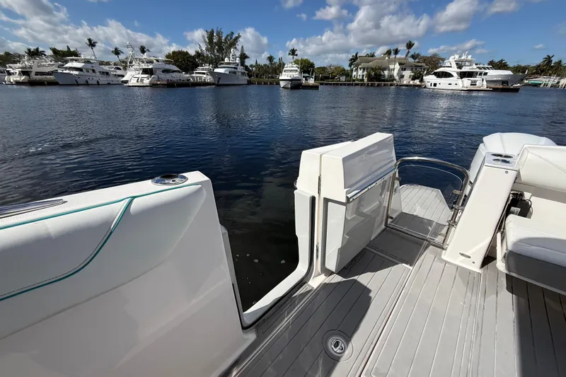  Yacht Photos Pics 2020 Regal 38 SAV boat deck with marina view, featuring luxurious seating and open water access.