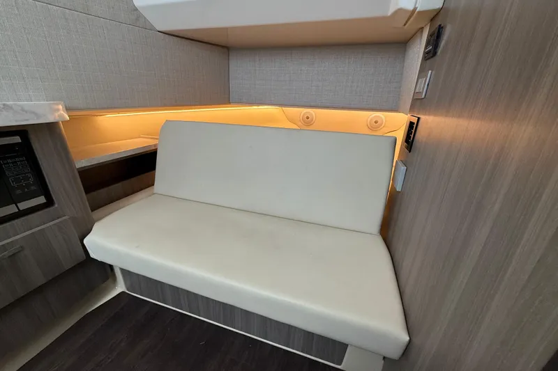  Yacht Photos Pics 2020 Regal 38 SAV interior with beige seating and ambient lighting.