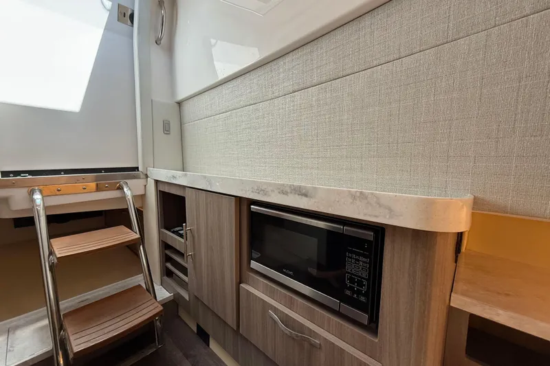  Yacht Photos Pics 2020 Regal 38 SAV yacht interior with microwave and wooden steps.