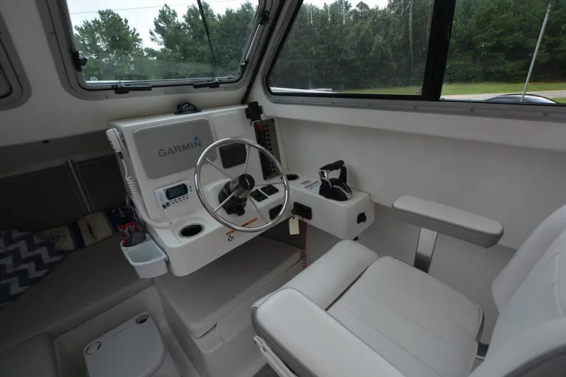 Still Yacht Photos Pics Interior of Parker 2420 boat, featuring Garmin navigation system and comfortable seating, 2025 model.