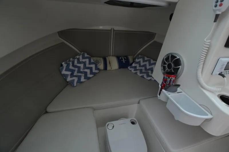 Still Yacht Photos Pics Cozy cabin interior of 2025 Parker 2420 boat with cushions and speaker.
