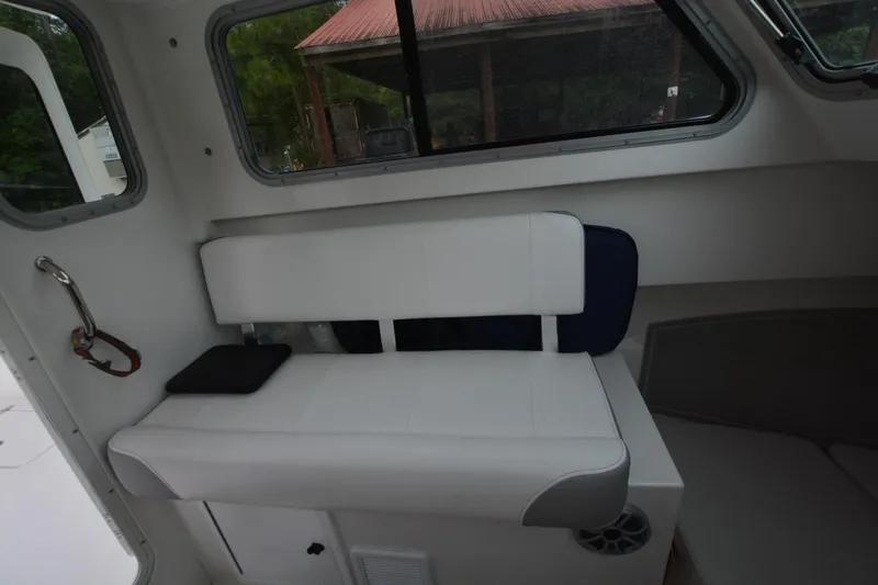 Still Yacht Photos Pics Interior of a 2025 Parker 2420 boat featuring a white cushioned bench seat.