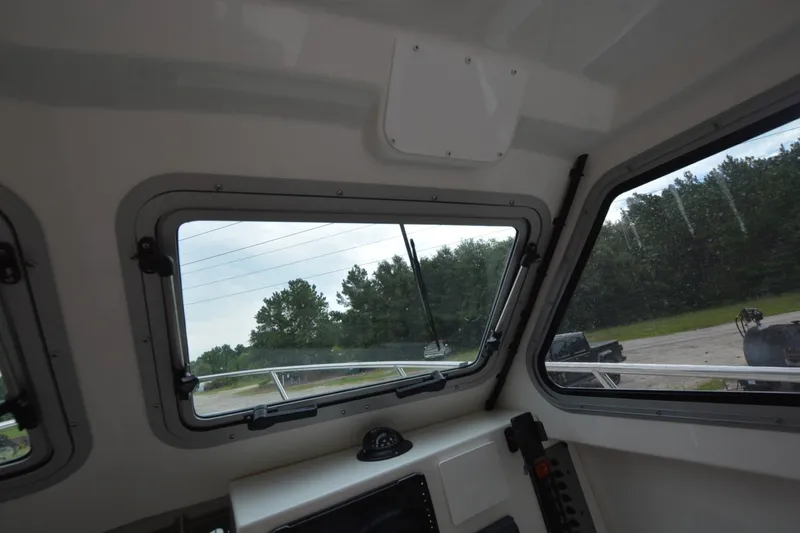 Still Yacht Photos Pics Interior view of Parker 2420 boat, showcasing windows and dashboard, 2025 model.