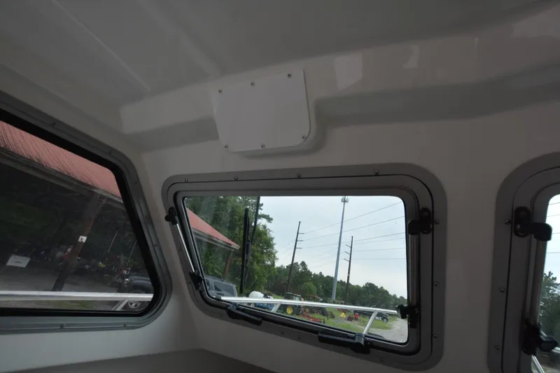 Still Yacht Photos Pics Interior view of Parker 2420 boat, showcasing windows and outdoor scenery, 2025 model.