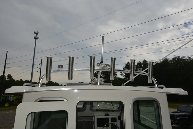 Still Yacht Photos Pics Rooftop view of 2025 Parker 2420 boat with rod holders and antenna.