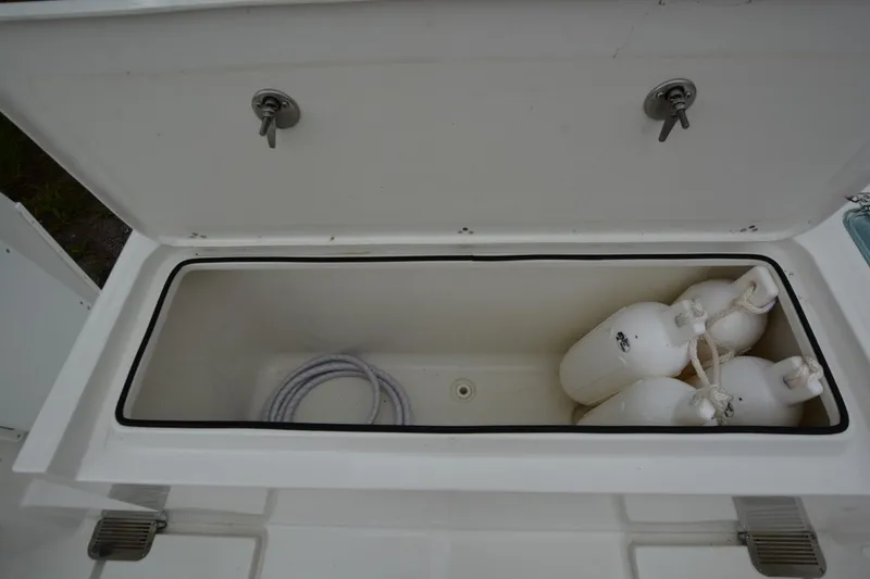 Still Yacht Photos Pics Open storage compartment on Parker 2420 boat, containing rope and white fenders, year 2025 model.