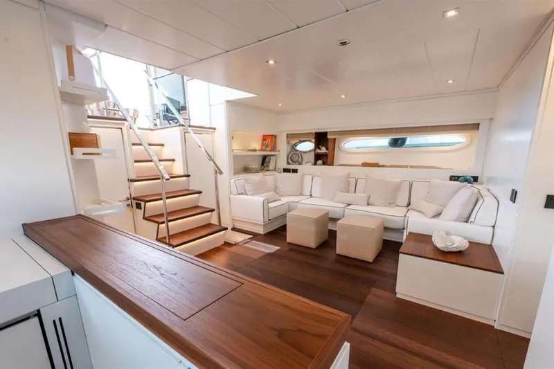 Mr K Yacht Photos Pics Luxurious interior of 2007 Cerri Cantieri Navali 86 Flying Sport yacht with modern seating and wooden accents.