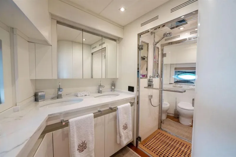 Mr K Yacht Photos Pics Luxurious yacht bathroom with dual sinks, glass shower, and elegant decor on Cerri Cantieri Navali 86.