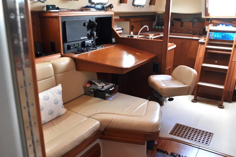Resolute Yacht Photos Pics Interior of 2002 Island Packet 420 yacht with cozy seating and navigation station.
