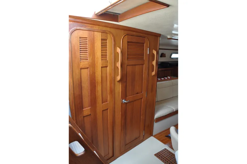 Resolute Yacht Photos Pics Interior of 2002 Island Packet 420 yacht featuring wooden cabinetry and seating area.