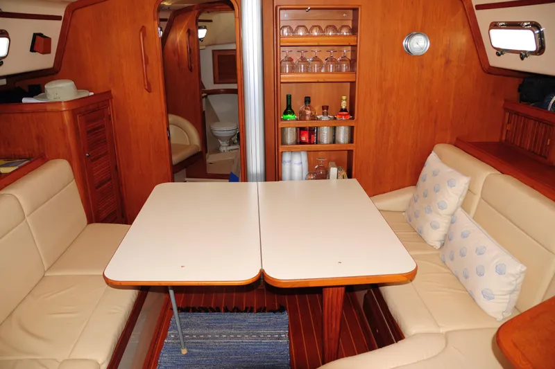 Resolute Yacht Photos Pics Interior of 2002 Island Packet 420 yacht with dining area and wooden cabinetry.
