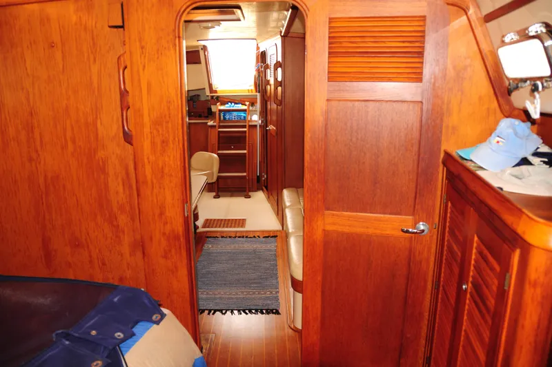 Resolute Yacht Photos Pics Interior of 2002 Island Packet 420 yacht with wooden cabinetry and cozy seating area.