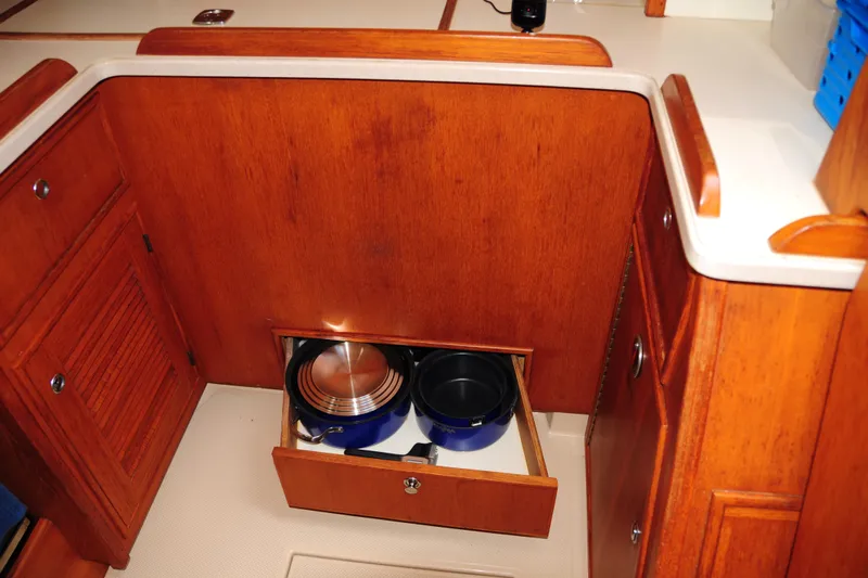 Resolute Yacht Photos Pics Wooden kitchen storage with open drawer on 2002 Island Packet 420 yacht.