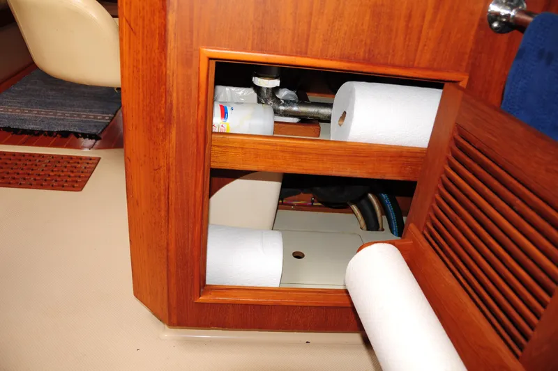 Resolute Yacht Photos Pics Interior storage compartment on 2002 Island Packet 420 yacht with paper towels and supplies.