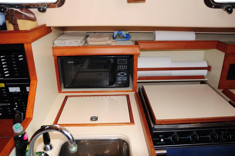 Resolute Yacht Photos Pics 2002 Island Packet 420 yacht kitchen with microwave, stove, and sink.