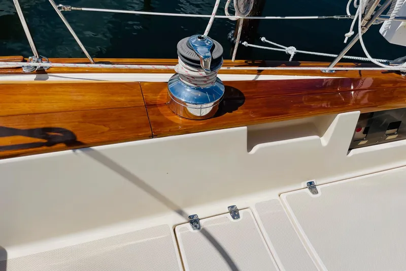 Resolute Yacht Photos Pics Polished winch on 2002 Island Packet 420 sailboat with wooden trim and white deck.