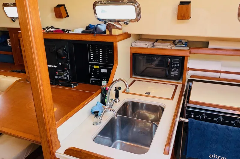 Resolute Yacht Photos Pics 2002 Island Packet 420 yacht interior with kitchen sink, microwave, and control panel.