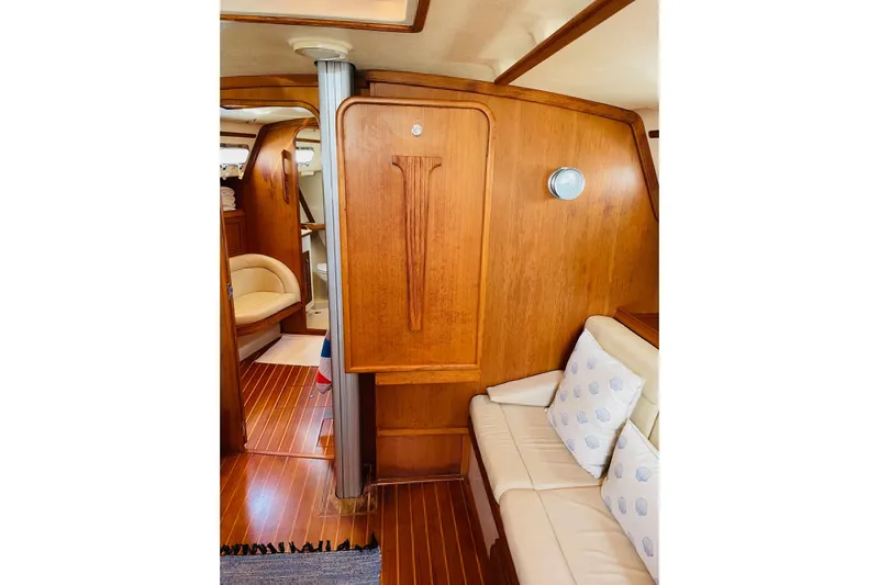 Resolute Yacht Photos Pics Interior of 2002 Island Packet 420 yacht with wooden paneling and cushioned seating.
