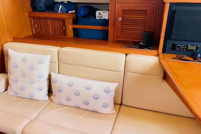 Resolute Yacht Photos Pics Interior of 2002 Island Packet 420 yacht with beige seating and shell-patterned pillows.