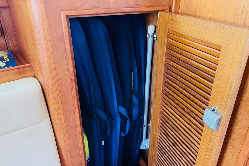Resolute Yacht Photos Pics Wooden cabinet with blue life jackets inside, on a 2002 Island Packet 420 yacht.