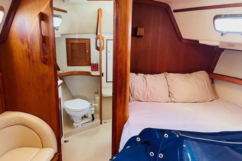 Resolute Yacht Photos Pics Cozy cabin interior of 2002 Island Packet 420 sailboat with bed and bathroom.