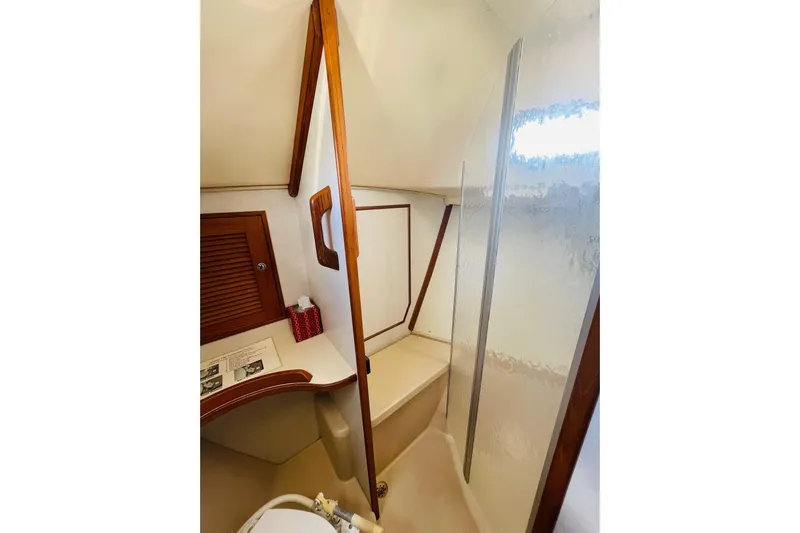 Resolute Yacht Photos Pics Interior of 2002 Island Packet 420 yacht bathroom with wooden accents and shower area.