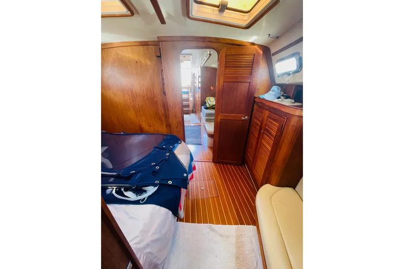 Resolute Yacht Photos Pics Interior of 2002 Island Packet 420 sailboat with wooden cabinetry and cozy furnishings.