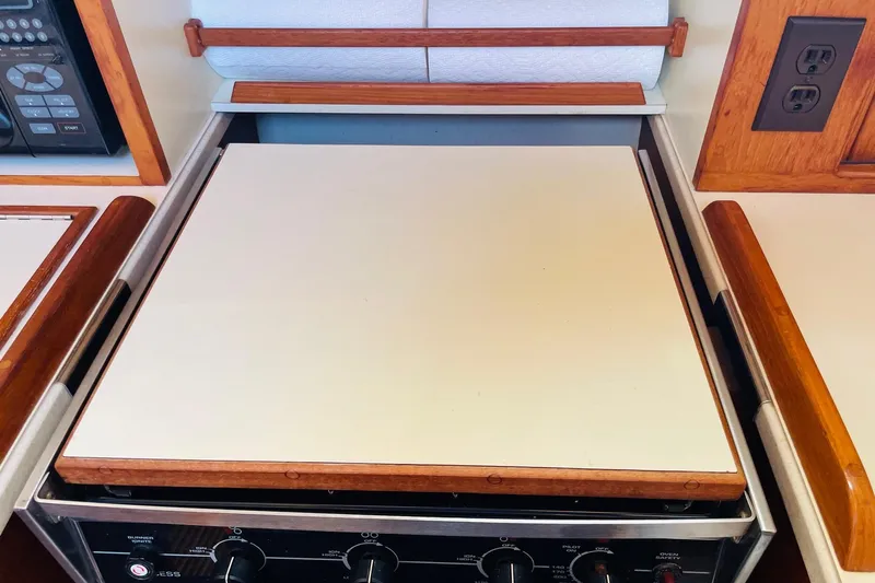 Resolute Yacht Photos Pics Stove area on 2002 Island Packet 420 yacht with wooden accents and control panel.