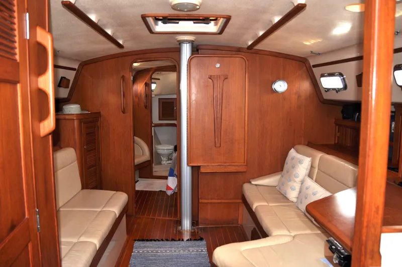 Resolute Yacht Photos Pics Interior of 2002 Island Packet 420 yacht with wooden finish and beige seating.
