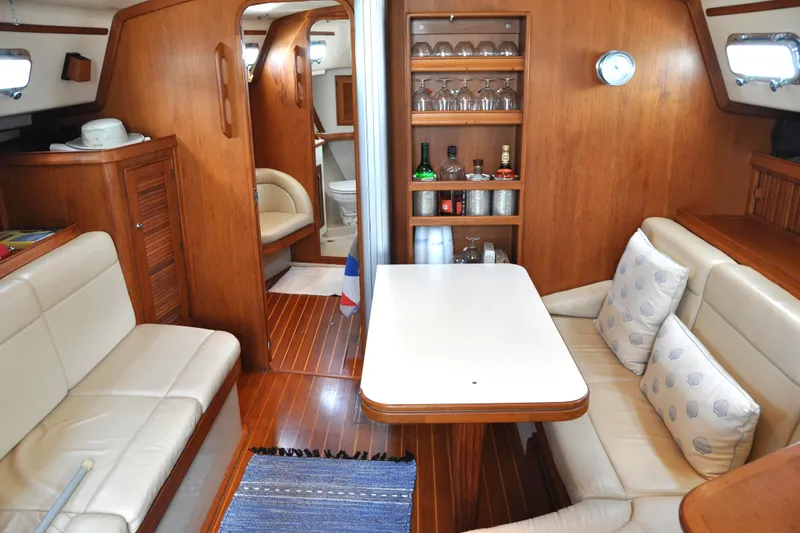 Resolute Yacht Photos Pics Luxurious interior of 2002 Island Packet 420 yacht with cozy seating and elegant wood finish.