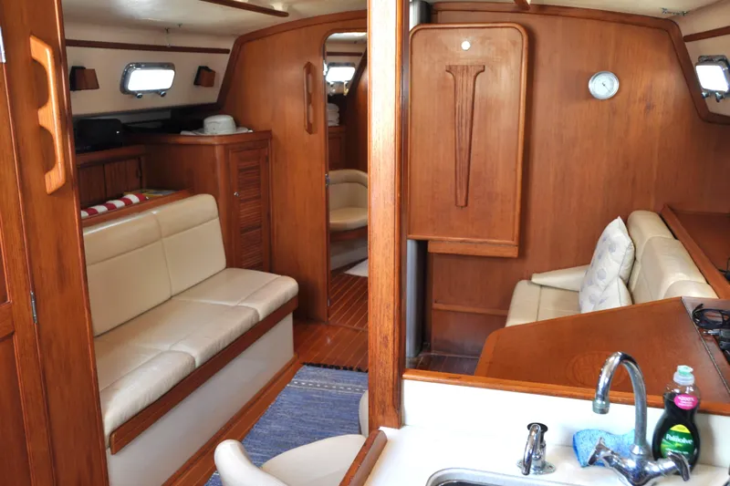 Resolute Yacht Photos Pics Interior of 2002 Island Packet 420 yacht with wooden finish and cozy seating.