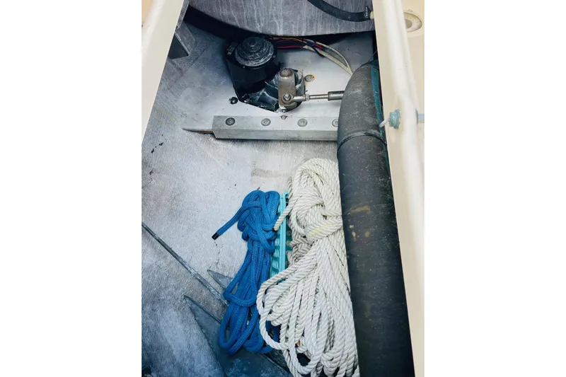 Resolute Yacht Photos Pics Storage compartment of 2002 Island Packet 420 sailboat with ropes and mechanical components.