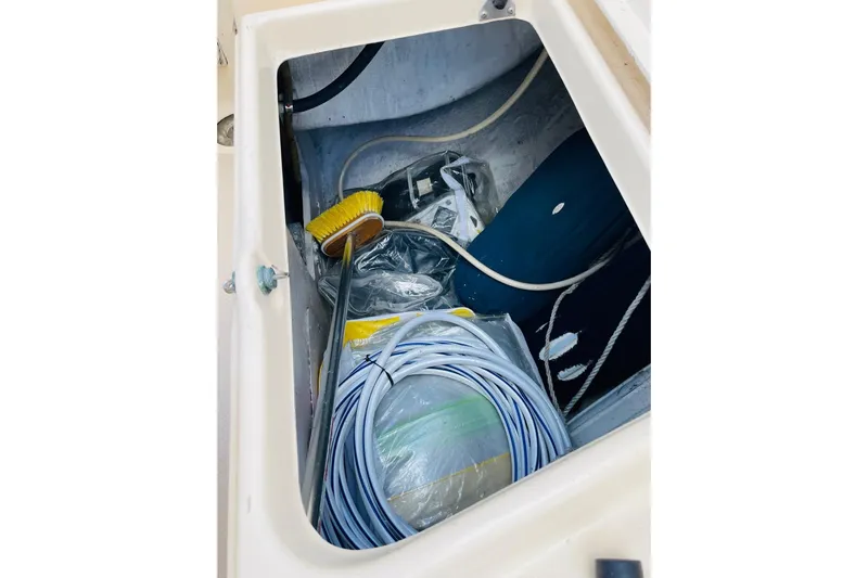 Resolute Yacht Photos Pics Storage compartment of 2002 Island Packet 420 sailboat with cleaning supplies and ropes.