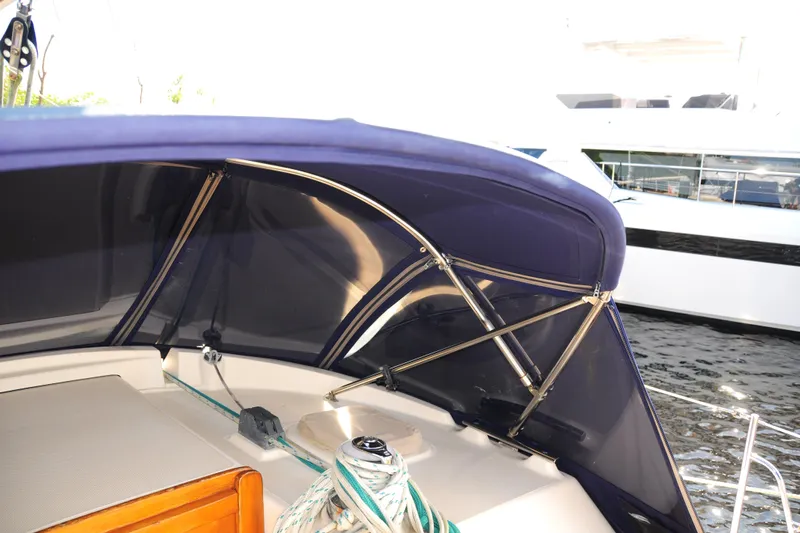 Resolute Yacht Photos Pics 2002 Island Packet 420 sailboat cockpit with blue canopy and ropes.