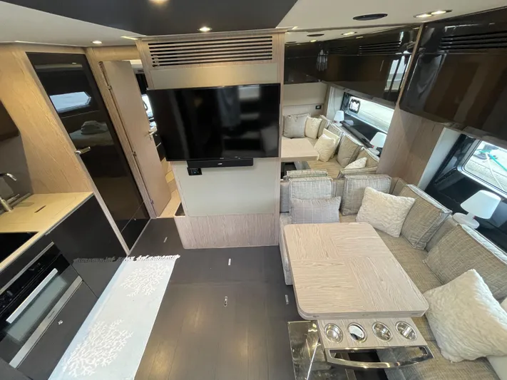  Yacht Photos Pics Luxurious interior of 2018 Azimut Atlantis 51 yacht with modern dining area and TV.