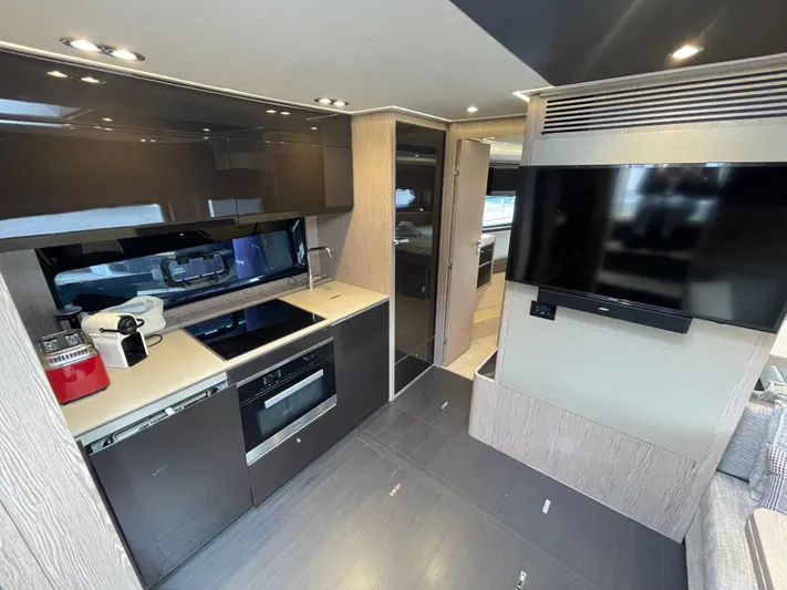  Yacht Photos Pics Modern kitchen interior of 2018 Azimut Atlantis 51 yacht with sleek appliances and TV.