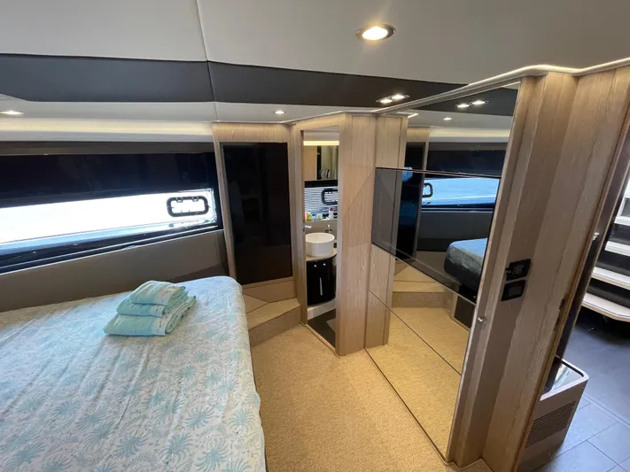  Yacht Photos Pics Luxurious interior of 2018 Azimut Atlantis 51 yacht, featuring a modern bedroom and ensuite bathroom.