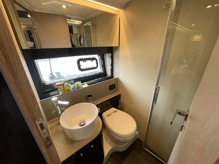  Yacht Photos Pics Luxurious bathroom in 2018 Azimut Atlantis 51 yacht with modern fixtures and elegant design.