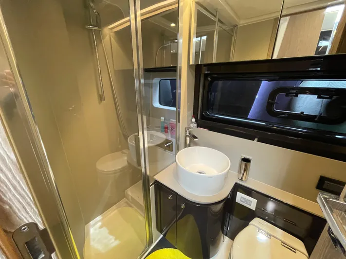  Yacht Photos Pics Luxurious bathroom in 2018 Azimut Atlantis 51 yacht with modern fixtures and glass shower.