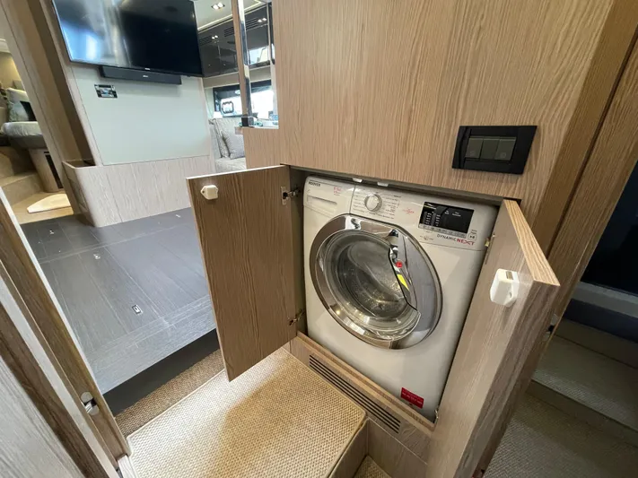  Yacht Photos Pics Built-in washing machine on 2018 Azimut Atlantis 51 yacht, wooden cabinetry, modern interior design.