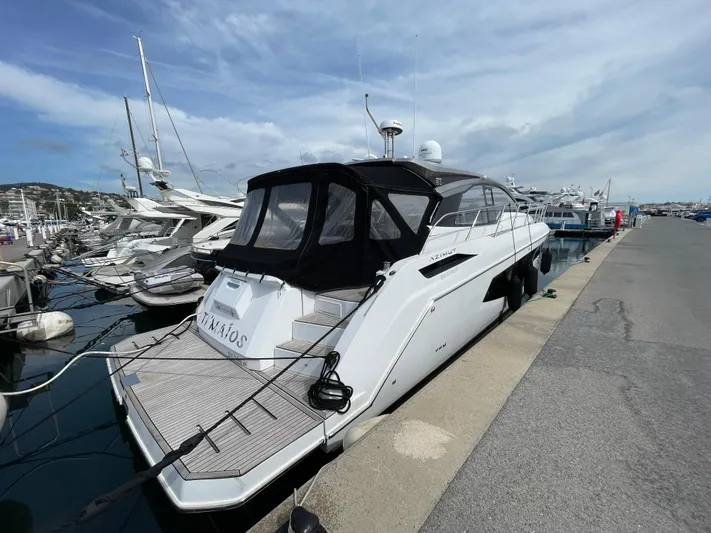  Yacht Photos Pics 2018 Azimut Atlantis 51 yacht docked at a marina under a cloudy sky.