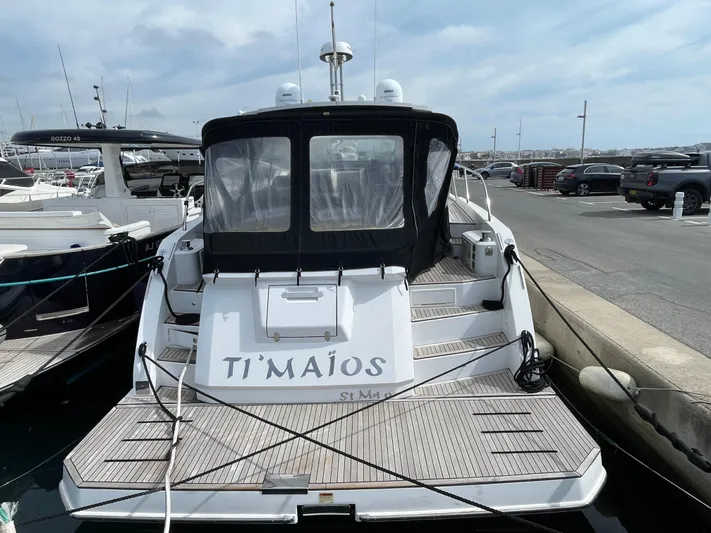 Yacht Photos Pics 2018 Azimut Atlantis 51 yacht docked at marina, rear view with covered deck.