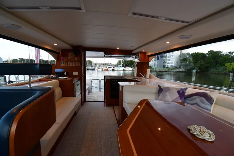 Promesa Yacht Photos Pics Interior of 2021 Hylas M44 yacht with elegant seating and marina view.