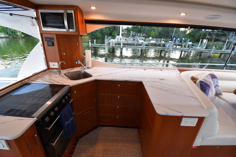 Promesa Yacht Photos Pics Luxurious 2021 Hylas M44 yacht interior with modern kitchen and scenic marina view.