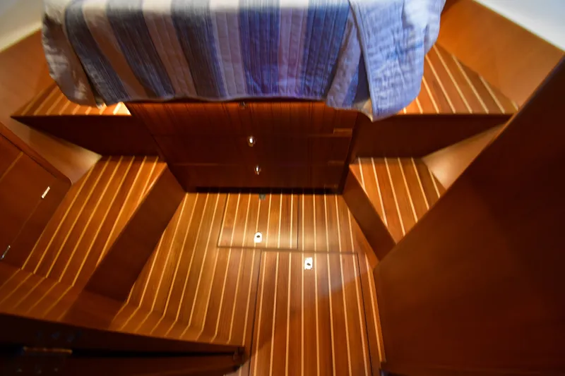 Promesa Yacht Photos Pics Interior of 2021 Hylas M44 yacht with wooden flooring and striped bedding.