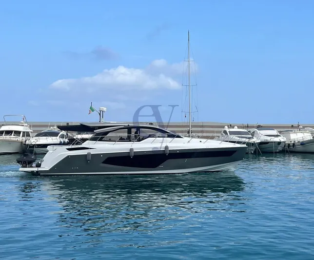 Yacht Photos Pics 2022 Azimut Atlantis 51 yacht docked in a marina under a clear blue sky.