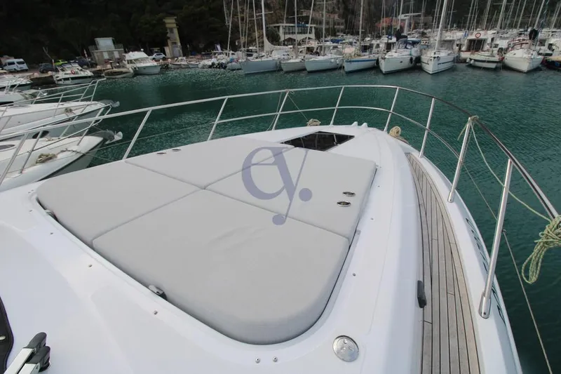  Yacht Photos Pics Azimut Atlantis 51 yacht deck, 2022 model, docked in a marina with surrounding boats.