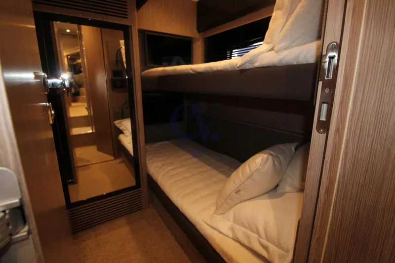  Yacht Photos Pics Bunk beds in the 2022 Azimut Atlantis 51 yacht cabin, featuring modern wood interior design.