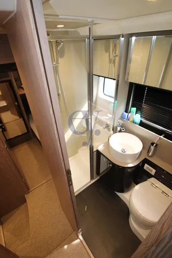  Yacht Photos Pics Luxurious bathroom in 2022 Azimut Atlantis 51 yacht with modern fixtures and shower.